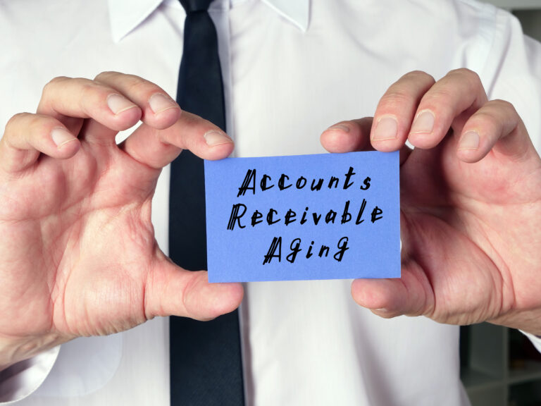 Hands holding a sign that says accounts receivable aging