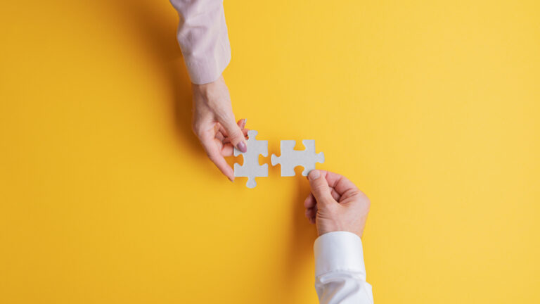 2 matching puzzle pieces on a yellow background