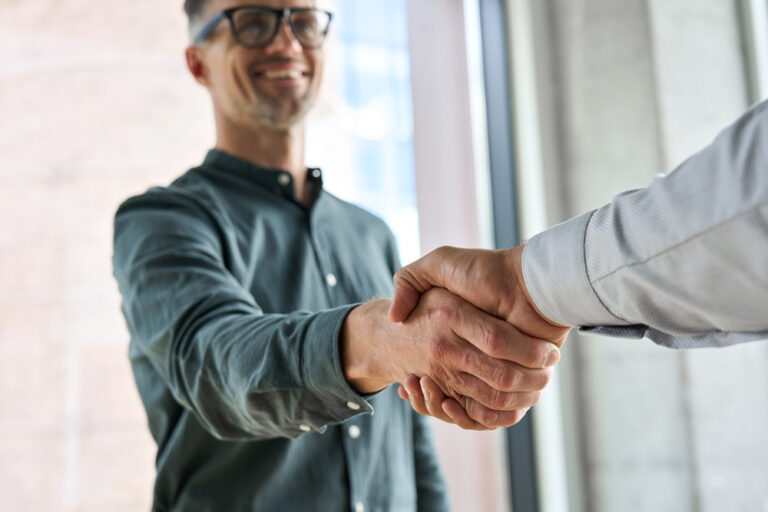 two business professionals shaking hands