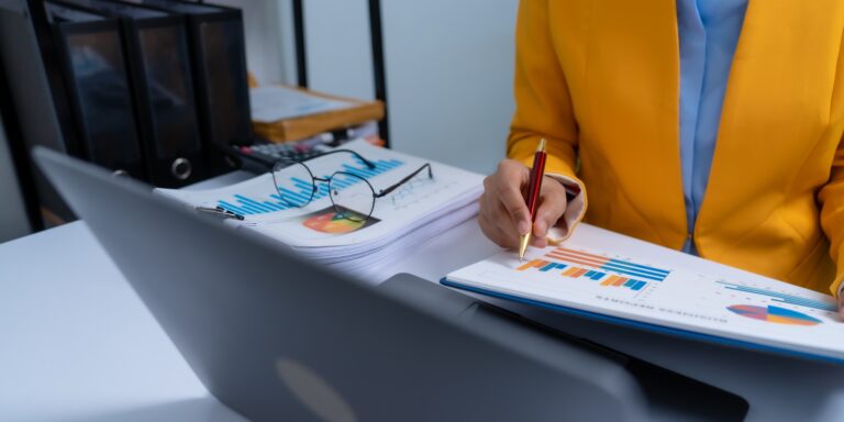 business person in yellow jacket doing account reconciliation