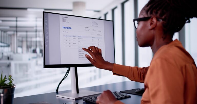 woman looking at an invoice on a computer