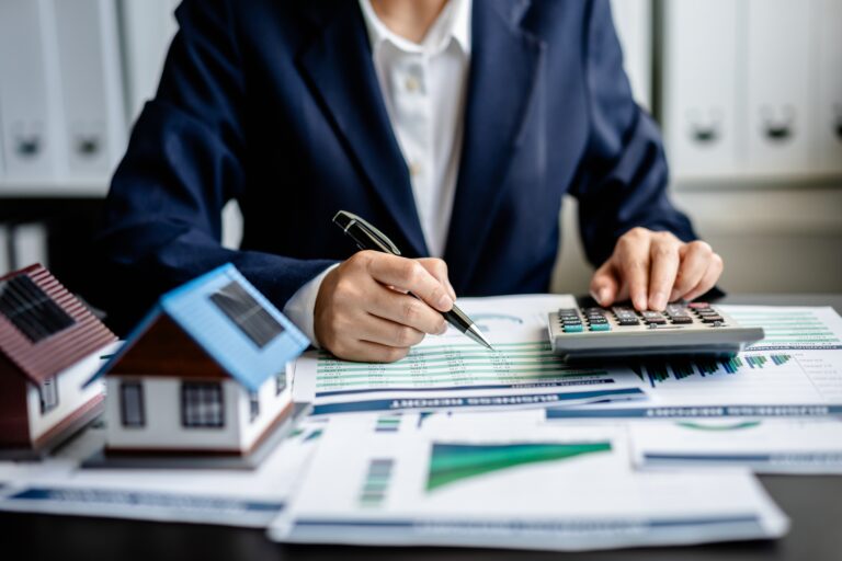 insurance provider with a calculator and papers on desk for accounting