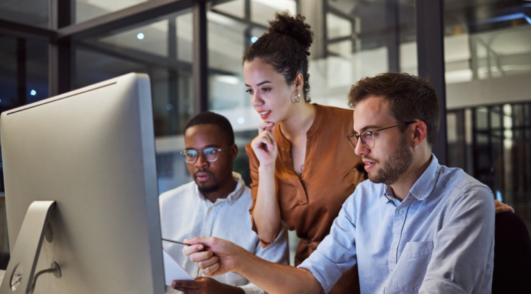 Global accounts receivable team in front of computer
