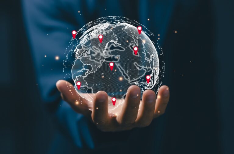 hand holding a small globe